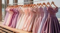 Pastel colorful bridesmaid dresses of all styles hang on the pegs