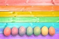 Pastel colorful rainbow painted eggs wood planks background Royalty Free Stock Photo