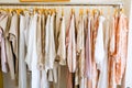 pastel colorful summer collection of natural clothes on hangers in retail fashion shop. Royalty Free Stock Photo