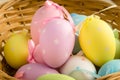Pastel Coloured Easter Eggs in a Straw Basket Royalty Free Stock Photo