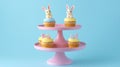 Pastel Easter Cupcakes with Bunny Decorations on Pink Stand Royalty Free Stock Photo