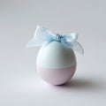 Pastel Easter Egg with Blue Lace Bow on White Background blue bow pink Royalty Free Stock Photo