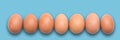 Pastel Easter eggs aligned, blue background