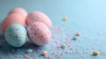 Pastel Easter Eggs on a Blue Background with Sprinkles Royalty Free Stock Photo