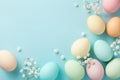 Pastel Easter eggs on blue background top view. Flat lay style