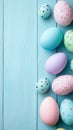 Pastel easter eggs border on blue wooden background Royalty Free Stock Photo