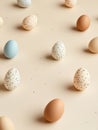 Pastel Easter eggs on light beige background with scattered speckles for spring decoration Royalty Free Stock Photo