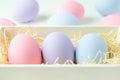 Pastel easter eggs at wooden basket
