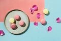 Pastel flatlay of yellow and pink vegan macaroons with rose Royalty Free Stock Photo