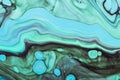 Pastel green waves with blue spots and gold sparkles. Acrylic Fluid Art. Abstract stone background or texture Royalty Free Stock Photo