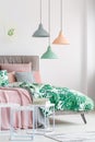 Pastel lamps above king-size bed