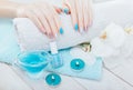 Pastel manicure with orchid and spa essentials. Combination of blue, white, pink colors and sparkles. Royalty Free Stock Photo