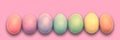 Pastel painted Easter eggs aligned in a row on pink panoramic background Easter web banner Royalty Free Stock Photo