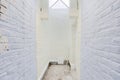 Pastel Painted Old Brick Hall Interior with Skylight and Concrete Flooring