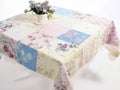 Pastel patchwork quilt table on a white background, featuring soft textures Royalty Free Stock Photo