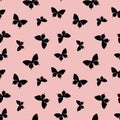 Pastel pink and black random butterfly silhouettes seamless repeat pattern design Royalty Free Stock Photo