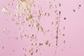 Pastel pink cardboard with gold potal drops and splashes. Creative background