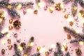 Pastel Pink Christmas Background. Festive frame of fir branches, toys and golden bokeh lights Royalty Free Stock Photo