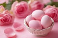 Pastel pink Easter eggs in porcelain bowl surrounded by pink roses on soft pink background Royalty Free Stock Photo