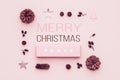 Pastel pink minimal christmas background. Beautiful christmas gift isolated on pastel pink background. Pink colored xmas gift box.