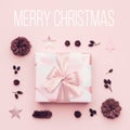 Pastel pink minimal christmas background. Beautiful christmas gift isolated on pastel pink background. Pink xmas gift box.