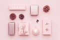 Pastel pink minimal christmas background. Beautiful nordic christmas gifts isolated on pastel pink background.