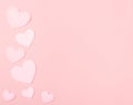 Pastel Pink Valentine Hearts on Pink Paper with space for copy, text or your words.  It`s a horizontal photo with an above view a Royalty Free Stock Photo