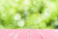 Pastel pink wooden table and blur nature tree green background Royalty Free Stock Photo
