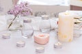 Pastel room interior decor with burning hand-made candle, books, flowers. Cozy and relax concept Royalty Free Stock Photo