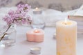 Pastel room interior decor with burning hand-made candle, books, flowers. Cozy and relax concept Royalty Free Stock Photo