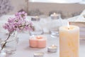Pastel room interior decor with burning hand-made candle, books, flowers. Cozy and relax concept Royalty Free Stock Photo