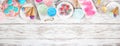 Pastel summer sweets top border over a rustic white wood banner background Royalty Free Stock Photo