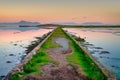 A pastel sunset over a dike with a view of the mountains. Mayo County, Ireland Royalty Free Stock Photo