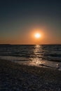 Pastel vibrant orange sunset on the seaside. Golden hour sunlight. Majestic dusk. Seascape in Rhodes, Greece. Reflection