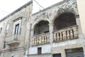 Pastel walls on narrow street with ornate doors and balconies