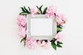 Pastel wooden frame decorated with peonies flowers, space for text. mock up