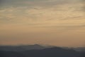 Pastel yellow sunset sky over mountains landscape Royalty Free Stock Photo