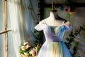pastelcolored summer dress on mannequin with flower basket