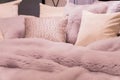 Pastep purple bedding - soft pillows and fur coverlet. coziness, comfort, interior and holidays concept Royalty Free Stock Photo