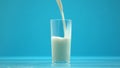 Pasteurized cow milk pouring in glass, organic nutrition, fresh food, calcium