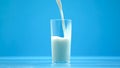 Pasteurized cow milk pouring in glass, organic nutrition, fresh food, calcium Royalty Free Stock Photo