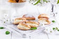 Pasties with cottage cheese and powdered sugar on a light wooden background. Traditional Russian pastry Sochnik.