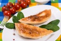 Pasties with sour cream, spinach and cherry tomatoes