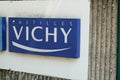 Pastilles Vichy lozenges with logo and sign and text front of entrance to the factory