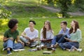 Pastime In Campus. Outdoor portrait of college friends resting after classes together Royalty Free Stock Photo