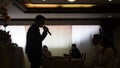 Pastor clergyman standing, holding a microphone delivering a sermon and advice to the new wedding couple in a civil gathering cong