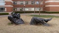 `Pastoral Dreamer`, a larger than life size bronze statue of a man lying in the grass on the campus of the University of Oklahoma.