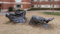 `Pastoral Dreamer`, a larger than life size bronze statue of a man lying in the grass on the campus of the University of Oklahoma.