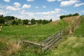 Pastoral Farm - Fence, Grass, Blue Sky and Clouds Royalty Free Stock Photo