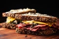 pastrami and swiss cheese sandwich on dark rye bread, shot from the side Royalty Free Stock Photo